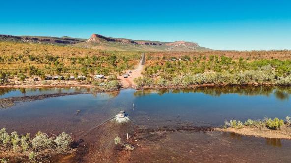 Geländewagen durchquert den Pentecost River vor der Kulisse der Cockburn Ranges in den Kimberleys.